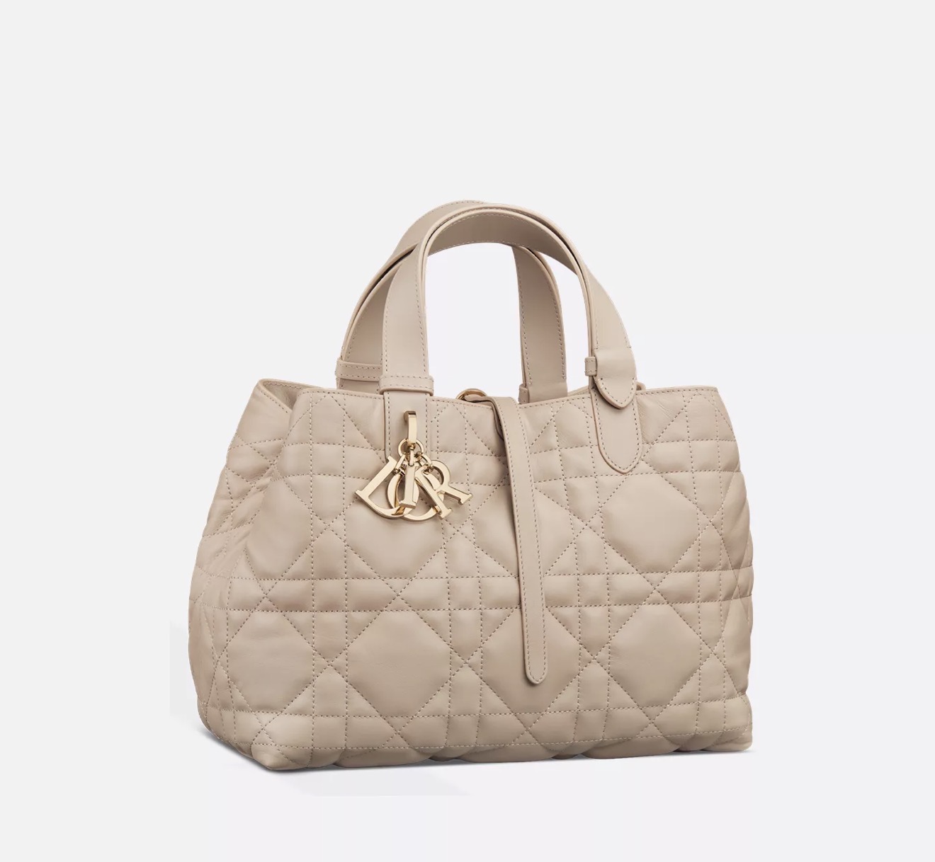 Nude quilted leather tote handbag with gold charm